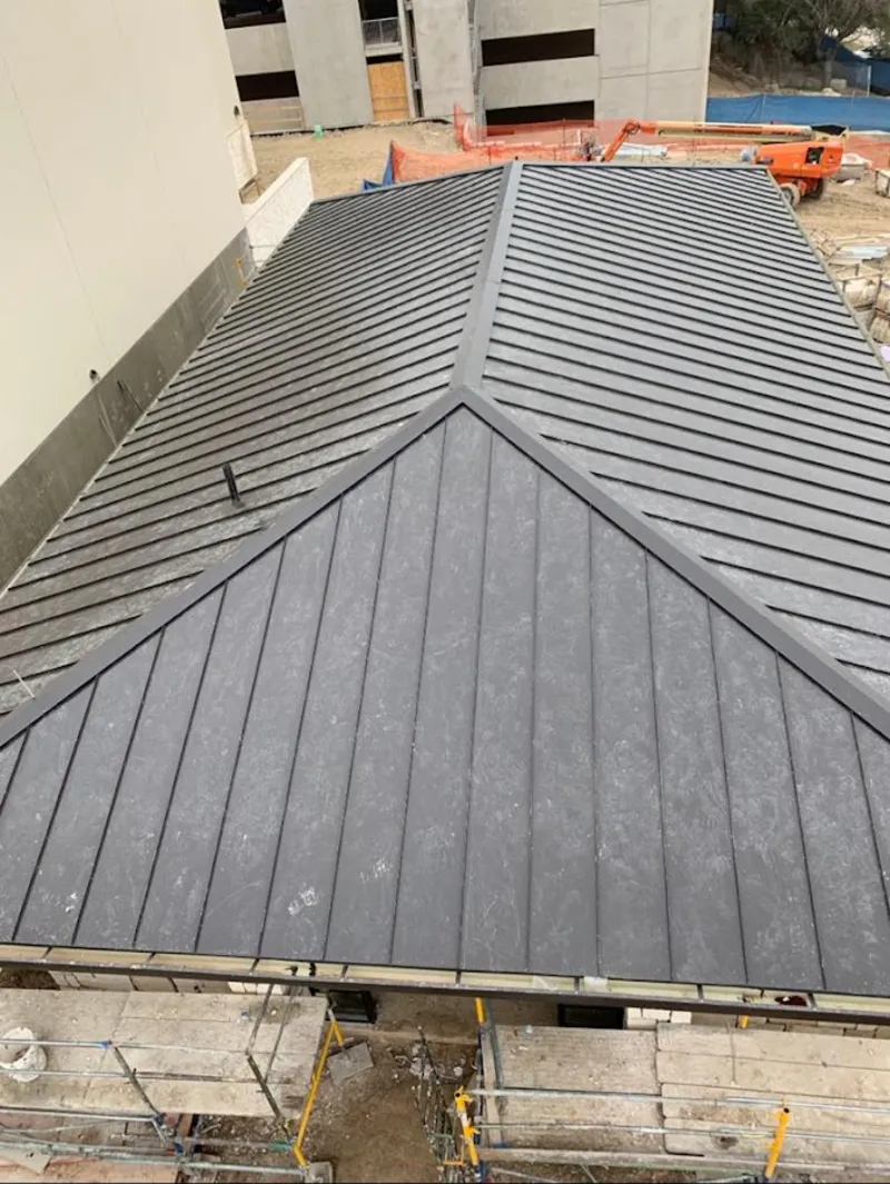 Commercial metal roof construction with crane equipment in East Cleveland